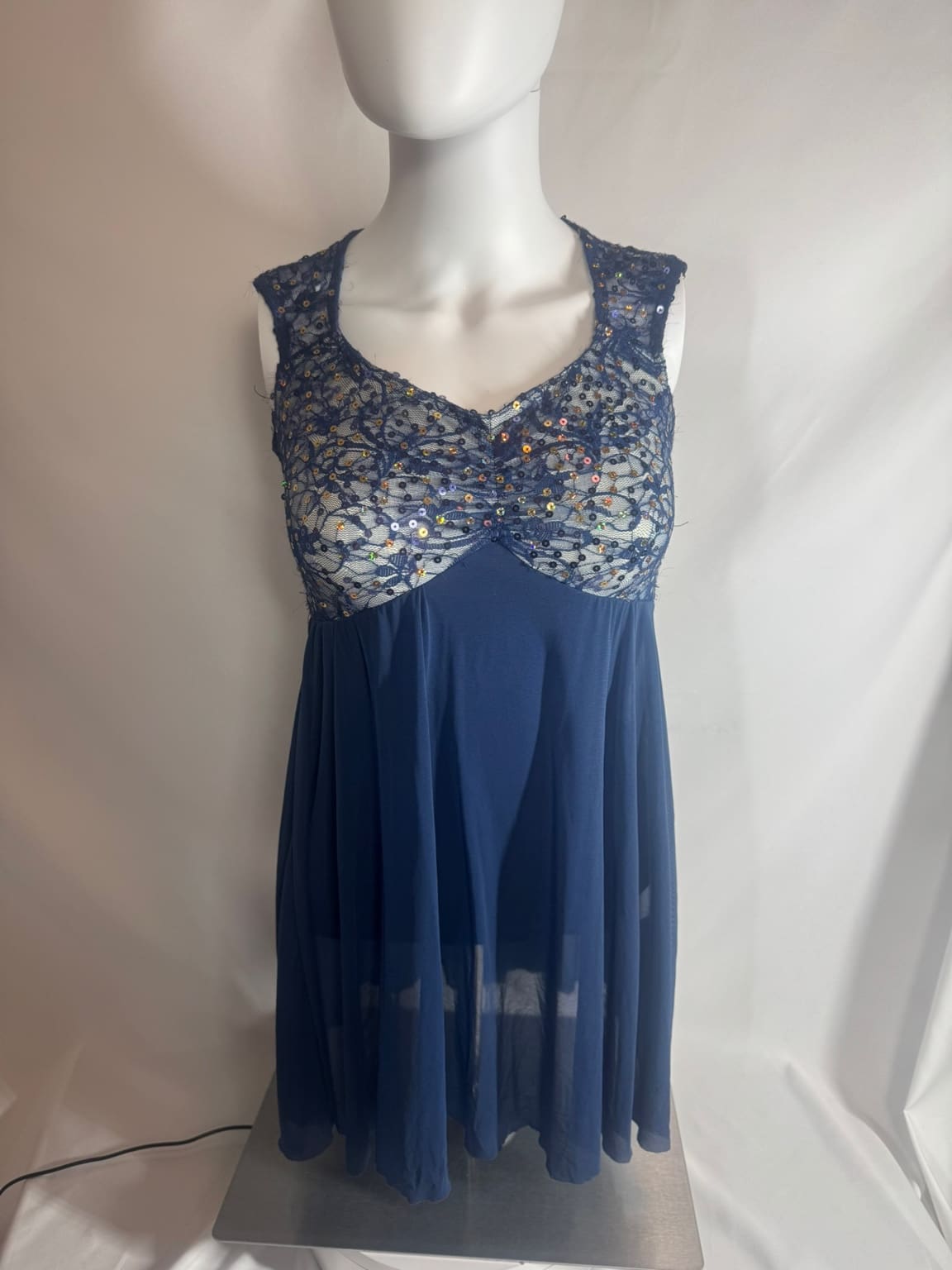 Front view of navy lace sequin open back Weismann skating dress