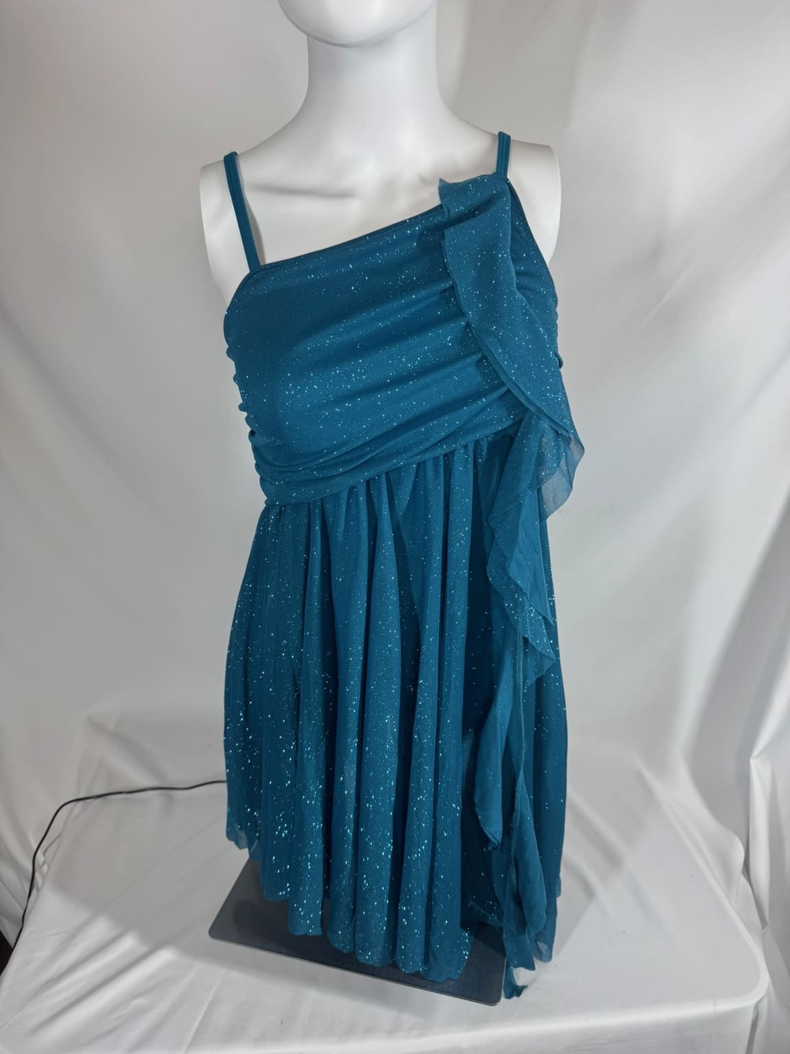 Front view of teal glitter Balera skating dress with asymmetrical draped bodice