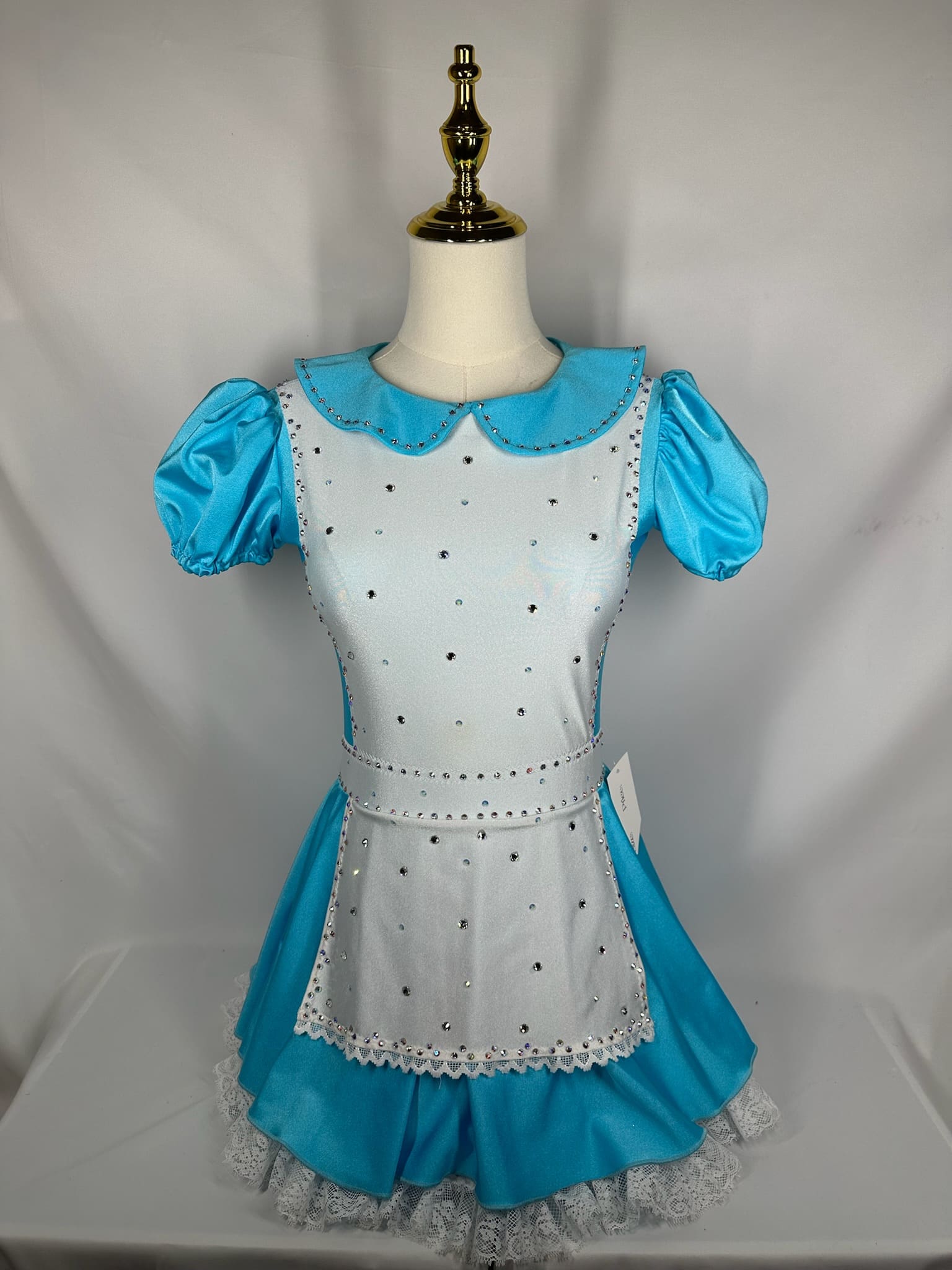 front view of Blue Storybook Apron Figure Skating Dress