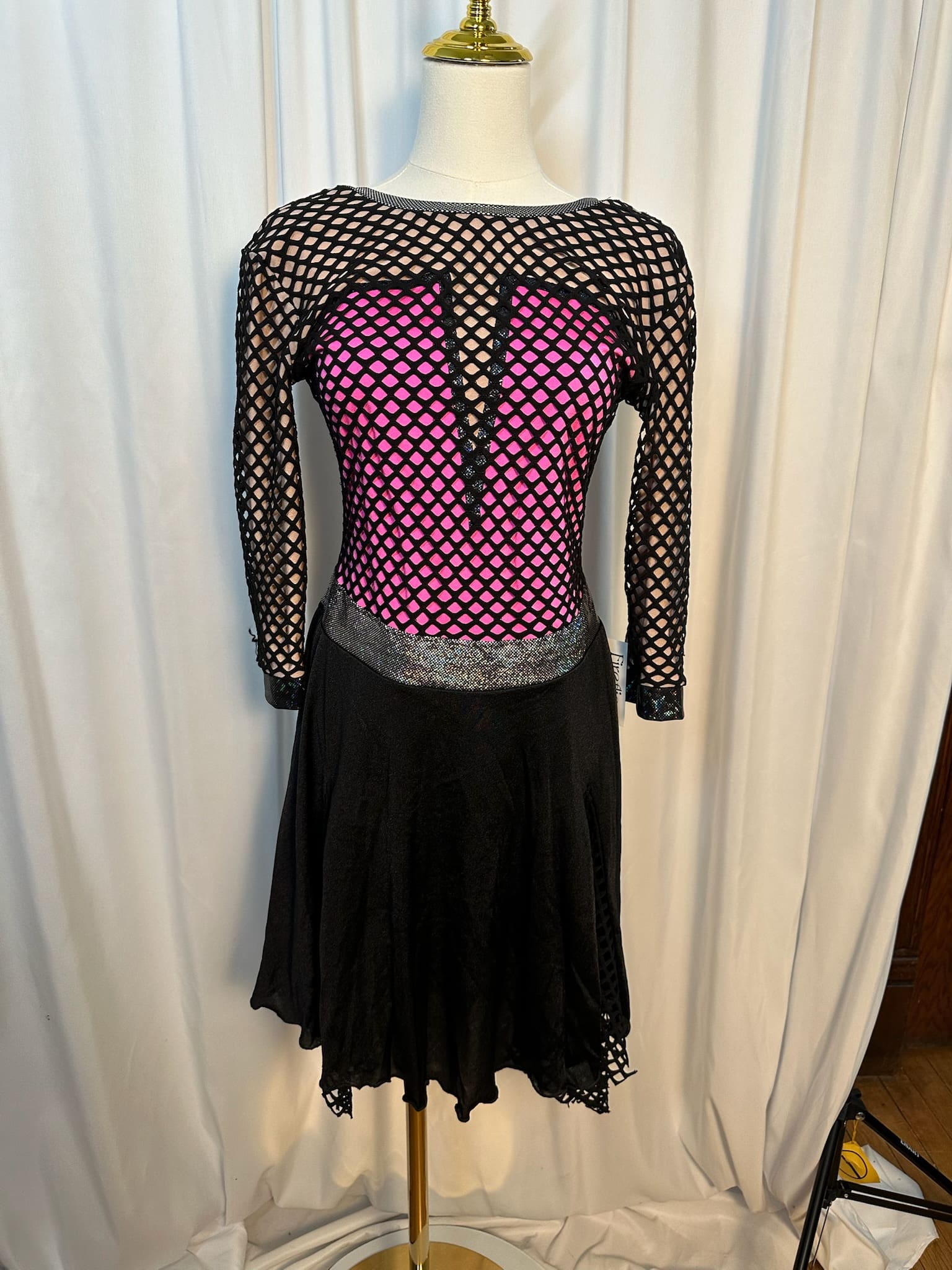 front view of Black and Hot Pink Fishnet Mesh Figure Skating Dress