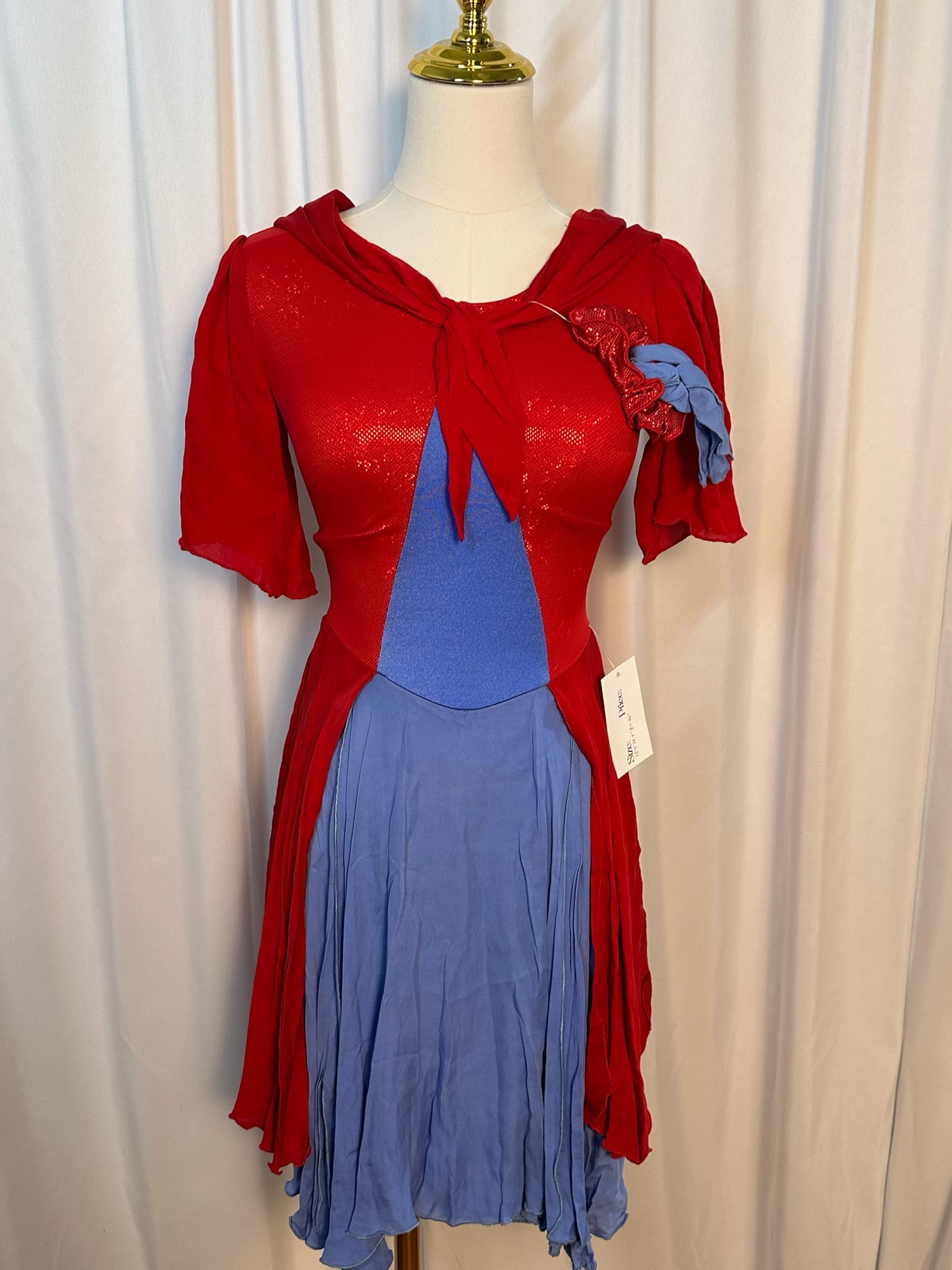 front view of Red and Blue Shimmer Layered Figure Skating Dress