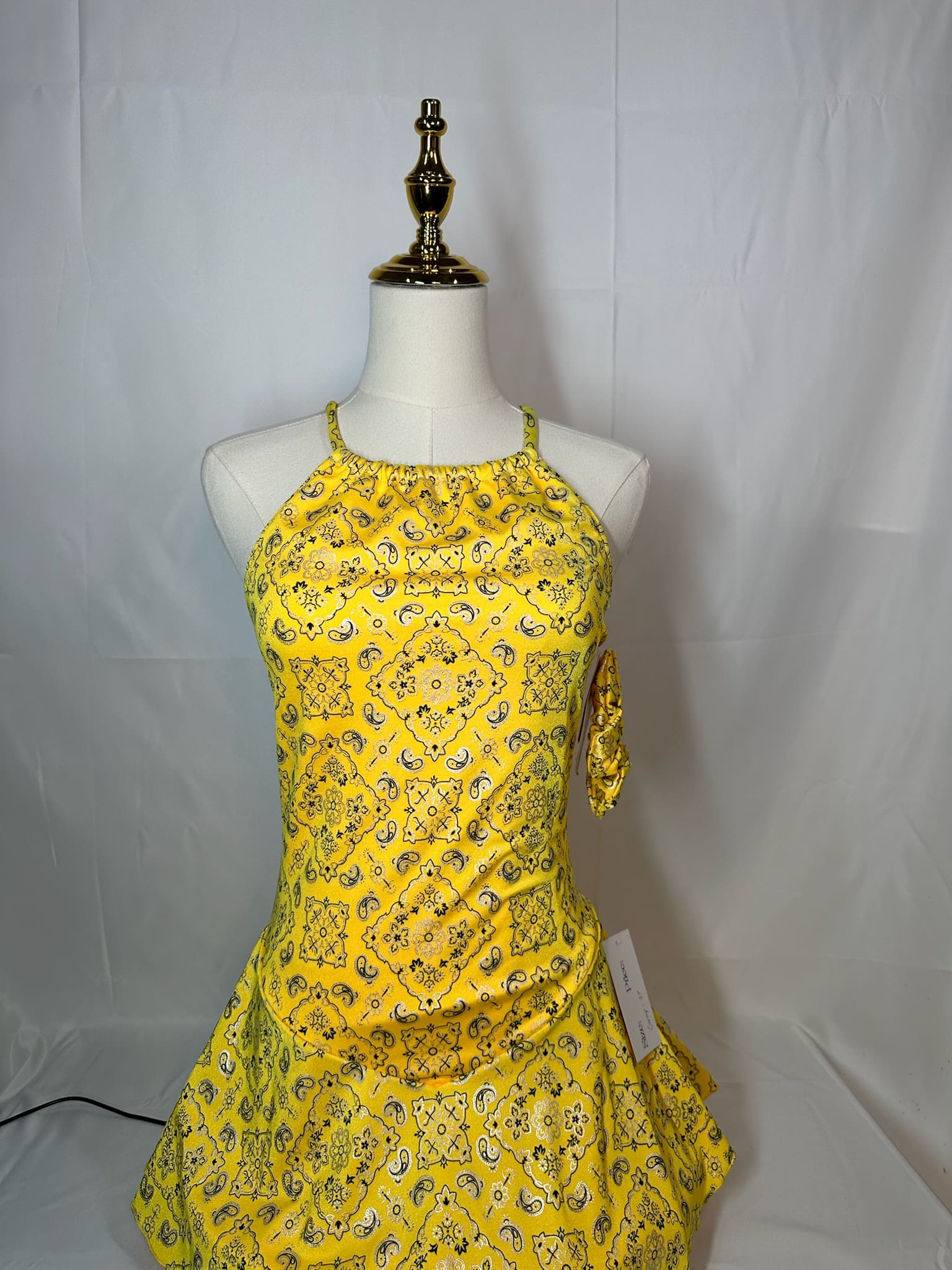 front view of Yellow Bandana Print Figure Skating Dress with Crisscross Straps