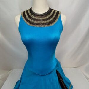 front view of Turquoise Gold Trim Mesh Yoke Figure Skating Dress