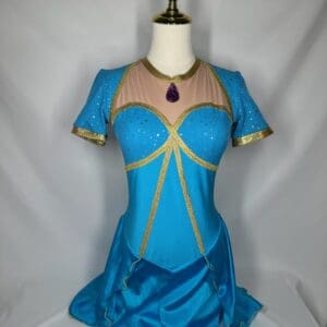 front view of Turquoise Gold Princess-Inspired Figure Skating Dress